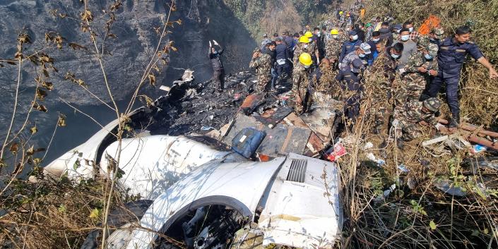 Rescue teams work to retrieve bodies at the crash site of an aircraft carrying 72 people in Pokhara in western Nepal January 15, 2023.