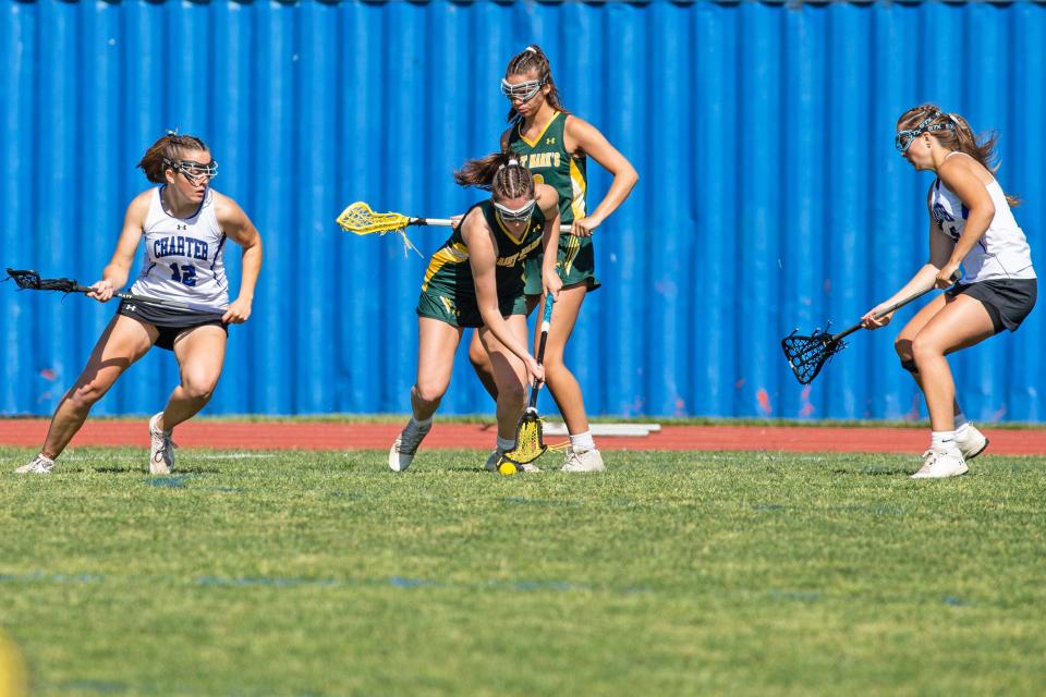 Saint Mark's junio Catherine Kaminski (21) gains control of a loose ball against Charter School of Wilmington during the first-round game in the DIAA Girls Lacrosse Tournament at Charter of Wilmington, Wednesday, May 17, 2023. Charter won 16-9.