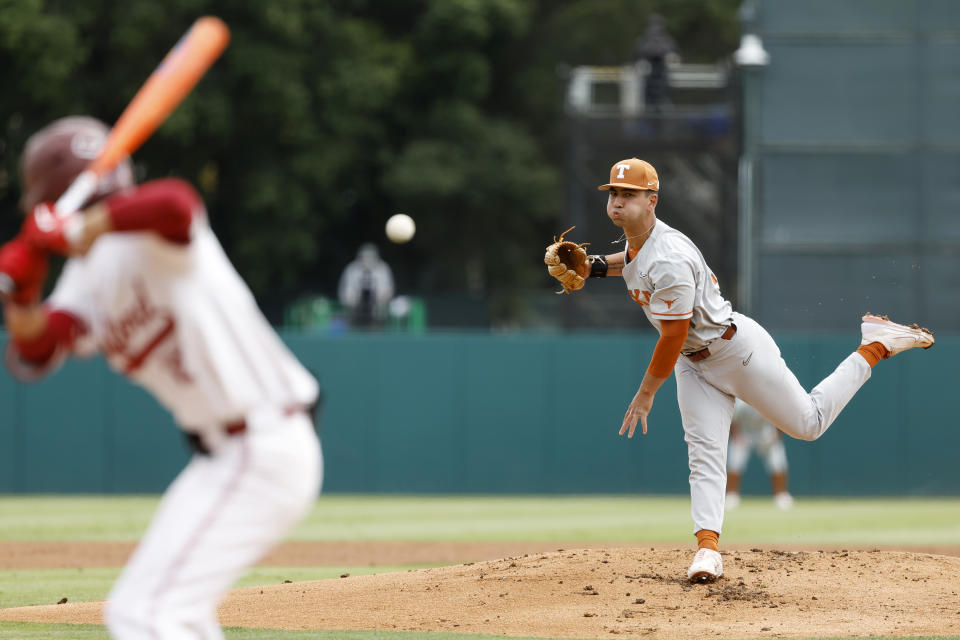 Texas' Lucas Gordon, right, throws the first pitch against Stanford in the first inning of an NCAA college baseball tournament super regional game in Stanford, Calif., Saturday, June 10, 2023. (AP Photo/Josie Lepe)