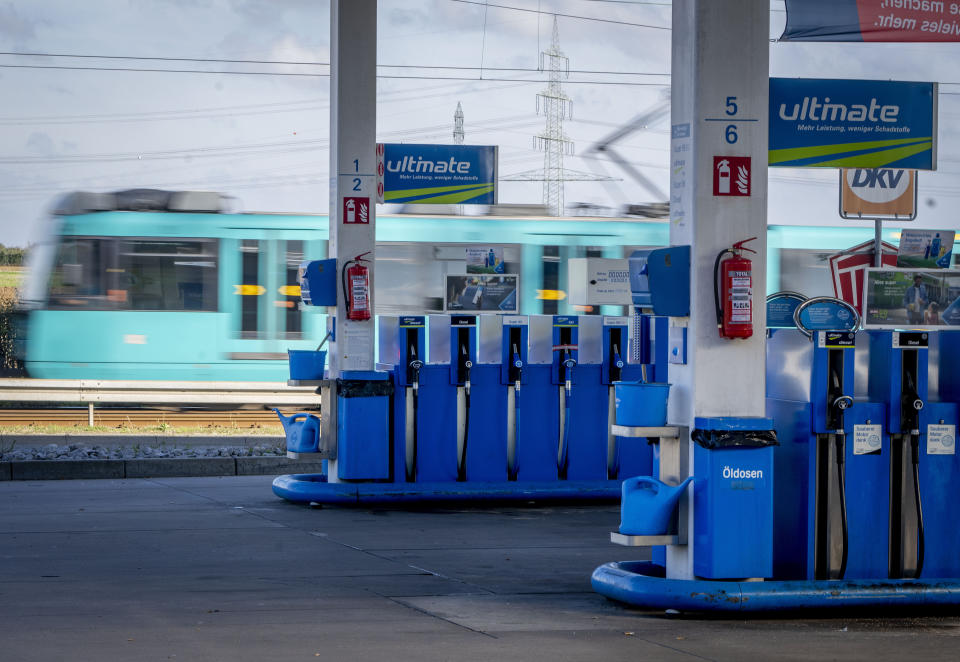 A subway passes by a gas station in Frankfurt, Germany, Wednesday, Oct. 5, 2022. A cut in oil production is on the table when OPEC oil-producing countries meet Wednesday. The OPEC+ alliance that includes Saudi Arabia and Russia is weighing a cut of a million barrels per day or more. The idea is to boost oil prices that have fallen from summer highs of over $100 to around $80 for U.S. crude. (AP Photo/Michael Probst)