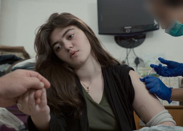 Julia Bruzzese in The Quiet Epidemic screening at Hot Docs 2022 festival. In an effort to heal damage cause d by Lyme disease, 15 - year - old Julia Bruzzese receives an injection of experimental stem cells at a clinic in New Delhi, India.