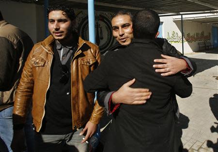 A Palestinian man is hugged by a relative after he was freed from a Hamas-run jail in Gaza City January 8, 2014. REUTERS/Suhaib Salem