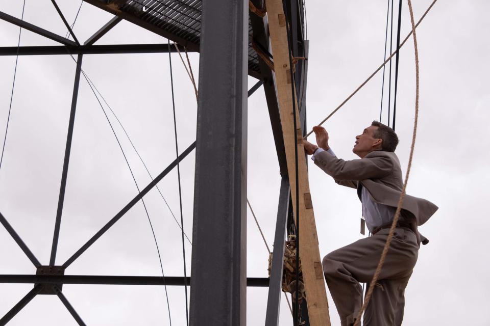 Cillian Murphy's J Robert Oppenheimer scales the tower that held the first nuclear bomb. (Universal)