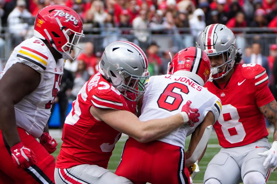 Oct 7, 2023; Ohio Stadium, Ohio, USA;
Ohio State Buckeyes linebacker Tommy Eichenberg (35) tackles Maryland Terrapins wide receiver Jeshaun Jones (6) as he attempts to run down the field during their game on Saturday, Oct. 7, 2023.