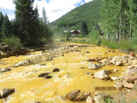 A plume of orange-yellow water gushed into Cement Creek and the Animas River after EPA workers accidentally breached a debris wall holding back the acid mine drainage at the Gold King Mine near Silverton, Colorado, on Aug. 5, 2015. This photogr