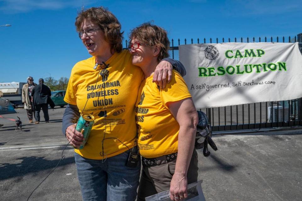 Camp Resolution leaders Sharon Jones, left, and Joyce Williams, right, embrace after a press conference announcing a formal lease agreement between the city and the encampment on Colfax street in North Sacramento on Saturday, April 1, 2023.
