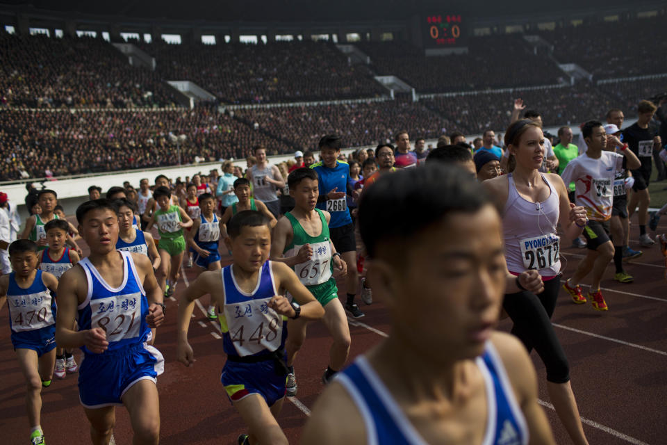 Runners take off from the starting line inside Kim Il Sung Stadium at the beginning of the Mangyongdae Prize International Marathon in Pyongyang, North Korea on Sunday, April 13, 2014. The annual race, which includes a full marathon, a half marathon, and a 10-kilometer run, was open to foreign tourists for the first time this year. (AP Photo/David Guttenfelder)