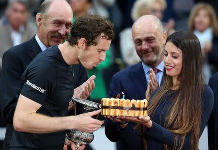 Tennis - Italy Open Men's Singles Final match - Novak Djokovic of Serbia v Andy Murray of Britain - Rome, Italy - 15/5/16 Murray blows out candle on his birthday cake after winning the match. REUTERS/Alessandro Bianchi