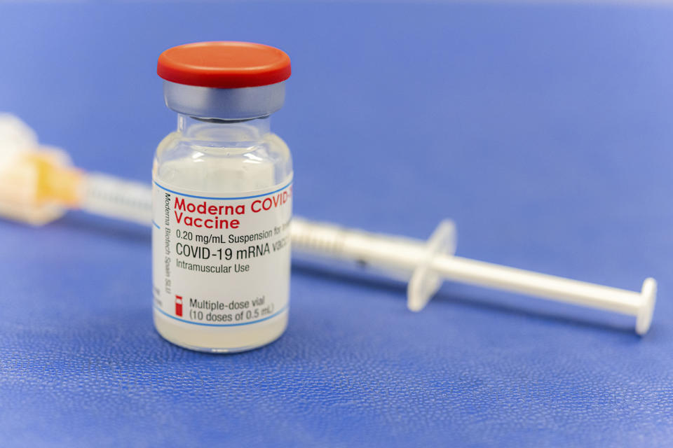 An ampoule Moderna vaccine against the COVID-19 disease, stand on the table at the Diakonie Hospital "DIAKO" vaccination ward in Bremen, Germany, Friday, Jan. 15, 2021. Besides the Pfizer/BioNTech vaccine, Moderna is the second corona vaccine approved in the European Union. (Mohssen Assanimoghaddam/dpa via AP)