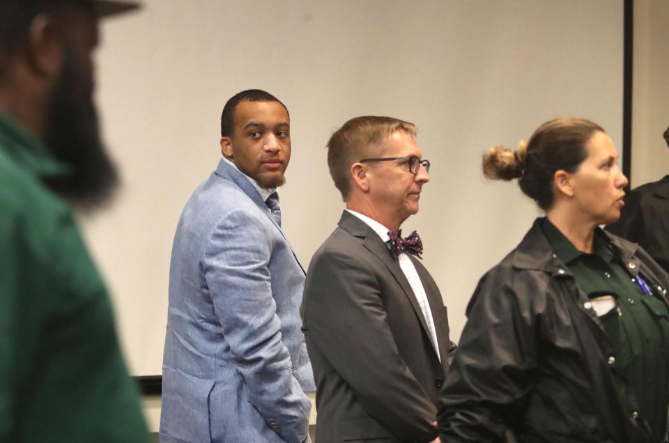 Damon Kemp, a former Bethune-Cookman University student, looks around the courtroom standing with his attorney, Richard Zaleski Jr., in the S. James Foxman Justice Center, Tuesday, May 23, 2023, as the jury leaves the courtroom during a break his trial for killing two people, including another B-CU student.