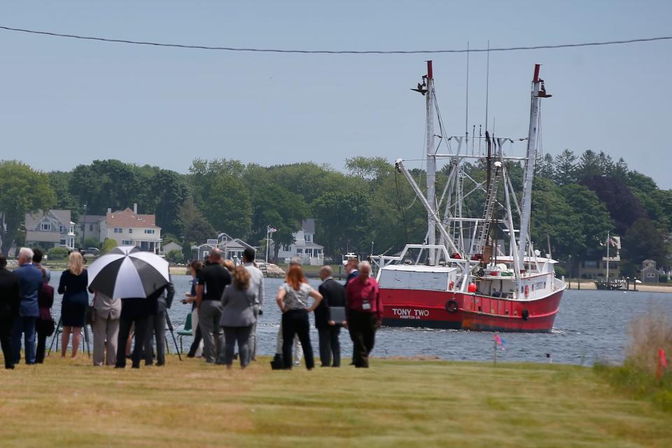 A fishing boat heads out to sea as the U.S. Environmental Protection Agency announces a seventy-two million dollar award to complete the cleanup of New Bedford harbor at a press conference held at the future Foss Terminal.