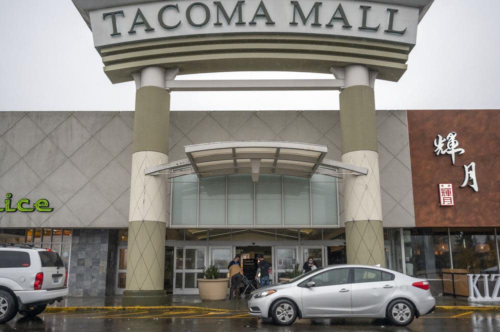 People walk into the north entrance of the Tacoma Mall, Saturday, Nov. 27, 2021, in Tacoma, Wash. (Pete Caster/The News Tribune via AP)