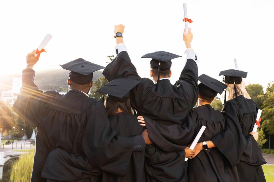 <p>Getty</p> A stock image of a group of graduates.