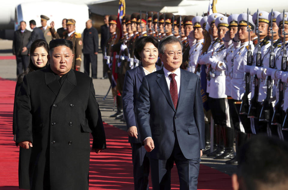 South Korean President Moon Jae-in, right, and North Korean leader Kim Jong Un inspect honor guard as they head to the Mount Paektu at Samjiyon airport in North Korea, Thursday, Sept. 20, 2018. (Pyongyang Press Corps Pool via AP)