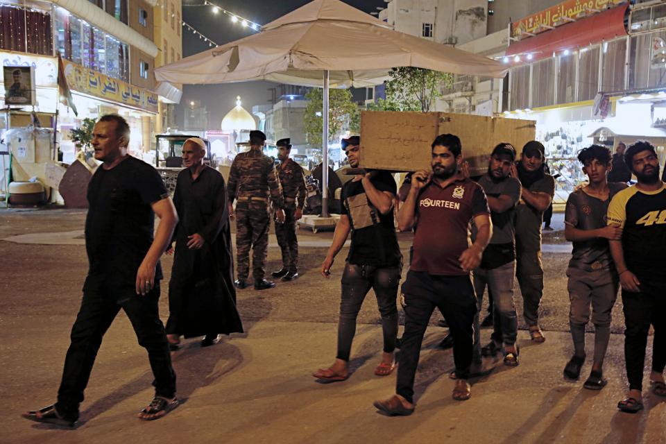 Mourners carry the coffin of Saleh Ahmed, 27, a protester killed during anti-government demonstrations in Najaf, Iraq, Monday, Oct. 28, 2019. (AP Photo/Anmar Khalil)