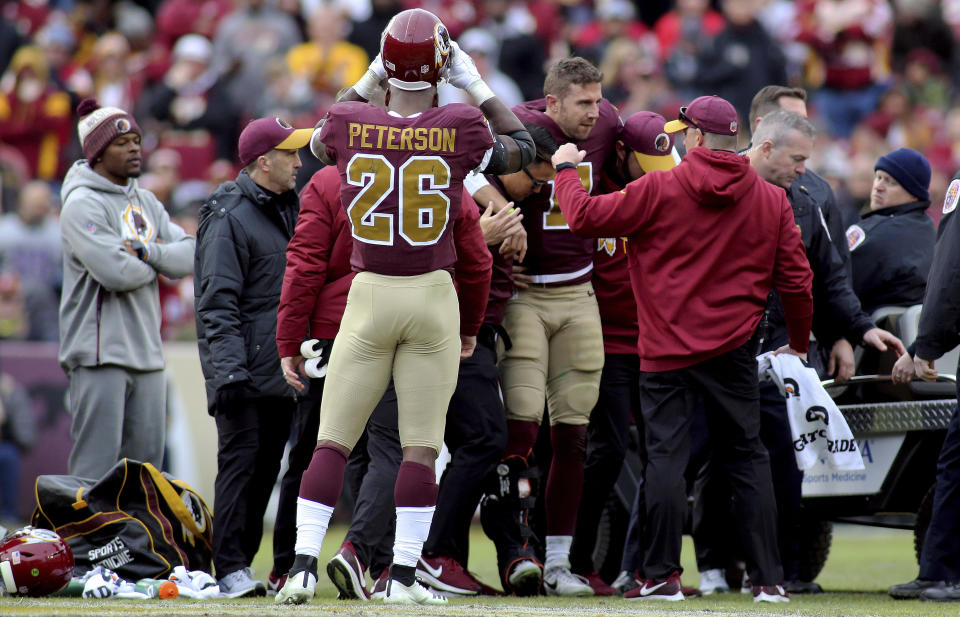 Washington Redskins quarterback Alex Smith (11) is carted off the field against the Houston Texans in an NFL game, Sunday, November 18, 2018 in Landover, Md. (AP Photo/Daniel Kucin Jr.)