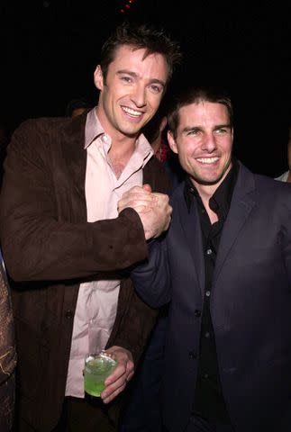 <p>Kevin Mazur/WireImage</p> Hugh Jackman and Tom Cruise in 2001