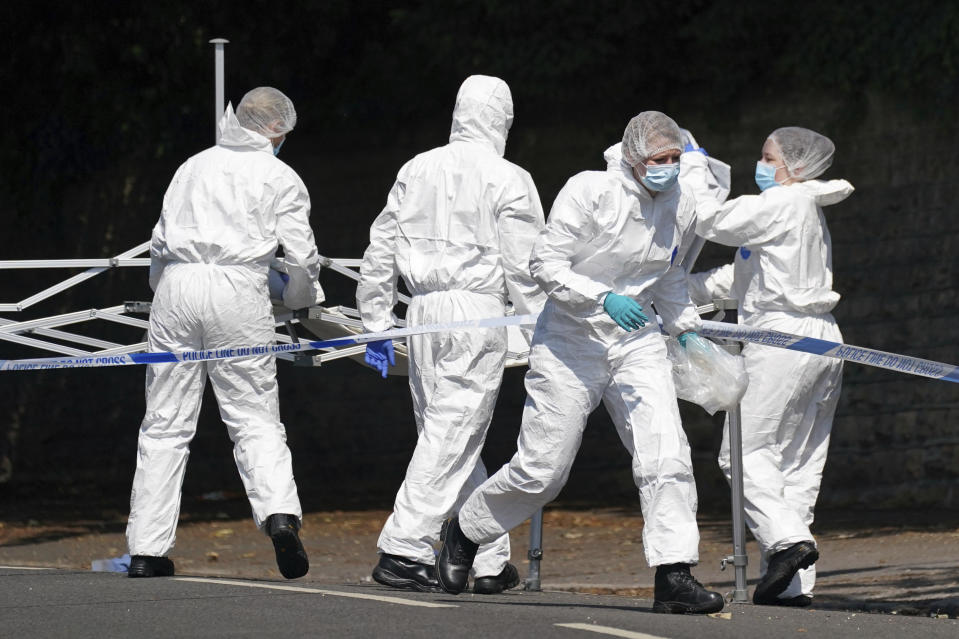 Police forensics officers erect a forensic tent on Magdala road, Nottingham after three people were killed in Nottingham city centre early on Tuesday, June 13, 2023. A man was arrested on suspicion of murder in the English city of Nottingham Tuesday after three people were found dead and three others were hit and injured by a van in related early-morning incidents, police said. (Jacob King/PA via AP)