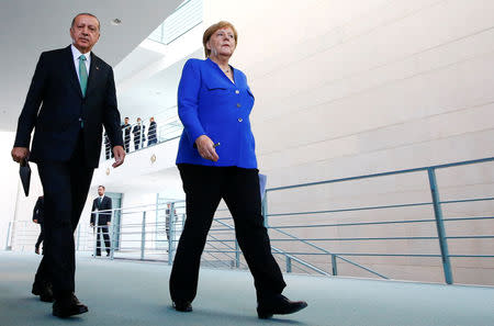 German Chancellor Angela Merkel and Turkish President Tayyip Erdogan leave after a news conference at the chancellery in Berlin, Germany, September 28, 2018. REUTERS/Fabrizio Bensch
