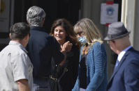 Marianne Campbell Smith, center, is greeted by supporters as she leaves the West Justice Center, Wednesday, Oct. 20, 2021, in Westminster, Calif., during a lunch break in her trial. Smith, who refused to leave a Costa Mesa grocery store, was convicted of trespassing on Wednesday after becoming the only person to go on trial in Orange County for not following pandemic-driven face-covering mandates at local businesses. (Jeff Gritchen/The Orange County Register via AP)