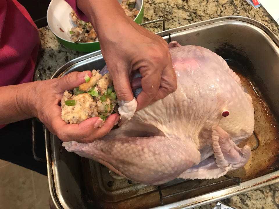 stuffing a turkey's cavity with a stuffing mixture