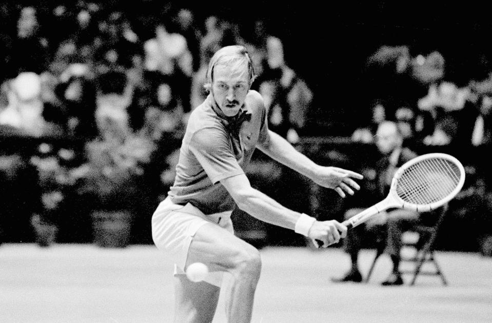 FILE - Stan Smith eyes the ball before returning the volley in the final round of the U.S. Indoor Tennis Championship in Philadelphia, Feb. 12, 1973. Smith, who won two Grand Slam singles titles and was part of seven U.S. Davis Cup winning teams, earned the Philippe Chatrier Award for making significant contributions to tennis on and off the court, the ITF said on Monday, May 30, 2022. (AP Photo/Brian Horton, File)