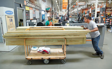 A customer purchases supplies at Home Depot to board-up his home at Kissimmee, in preparation for the arrival of Hurricane Irma making landfall, in Florida, U.S. September 7, 2017. REUTERS/Gregg Newton