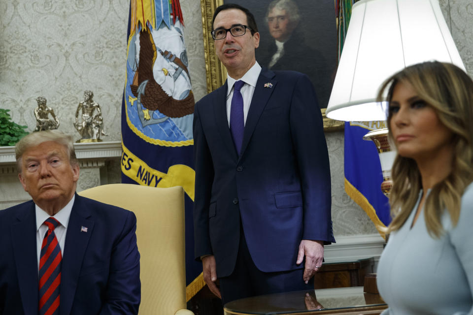 President Donald Trump and first lady Melania Trump listen as Treasury Secretary Steve Mnuchin announces sanctions on Iran during a meeting with Australian Prime Minister Scott Morrison in the Oval Office of the White House, Friday, Sept. 20, 2019, Washington. (AP Photo/Evan Vucci)