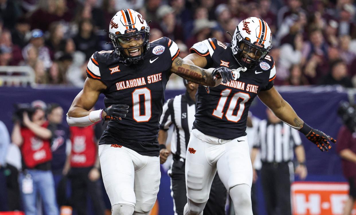 Dec 27, 2023; Houston, TX, USA; Oklahoma State Cowboys wide receiver Rashod Owens (10) celebrates with running back Ollie Gordon II (0) after scoring a touchdown during the first quarter against the Texas A&M Aggies at NRG Stadium. Mandatory Credit: Troy Taormina-USA TODAY Sports