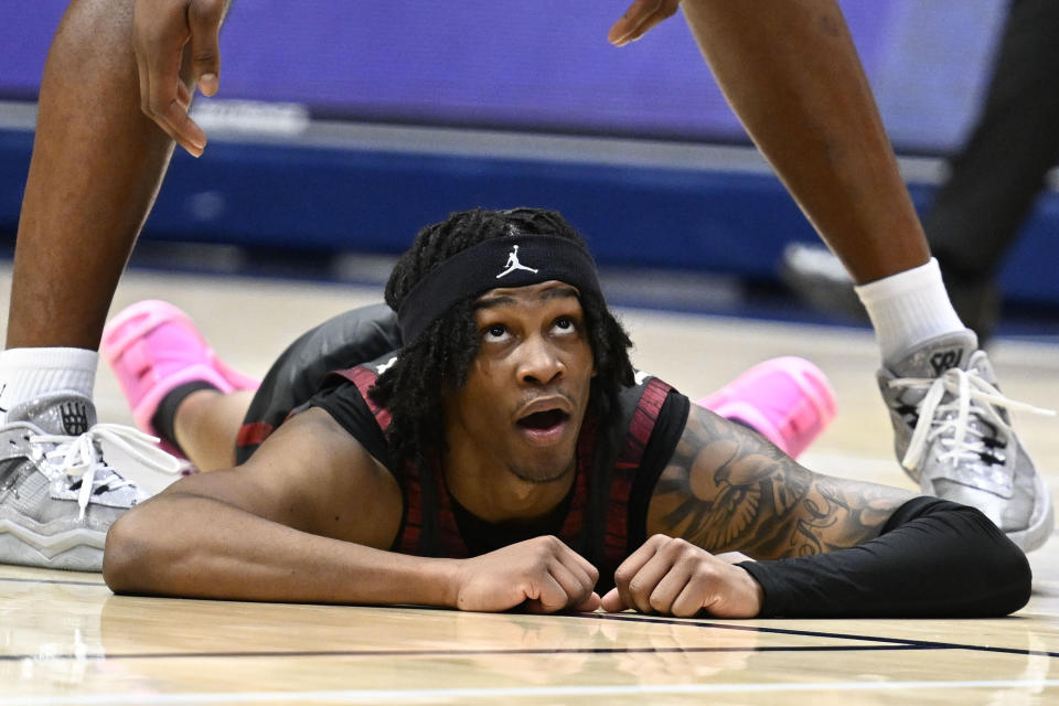 Oklahoma guard Javian McCollum looks up after shooting during the second half of an NCAA college basketball game against Southern California, Friday, Nov. 24, 2023, in San Diego. (AP Photo/Denis Poroy)