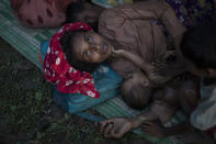 <p>Rohingya Muslim refugees sleep under a makeshift shelter in a clearing in a forest after crossing the border from Myanmar on Sept. 8, 2017 in Gundum, Bangladesh. (Photo: Dan Kitwood/Getty Images) </p>