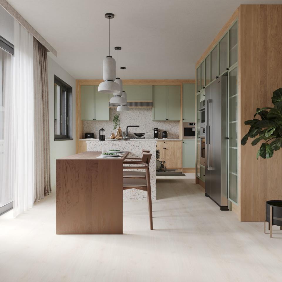 A kitchen with light laminate flooring