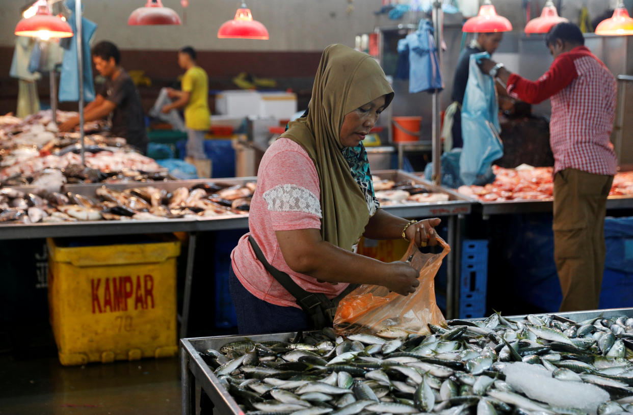 People buying fish at a wet market in Johor Bahru in April last year. (Reuters file photo)