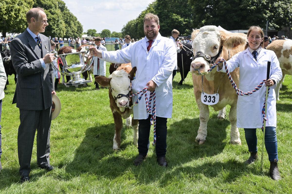 The Duke of Edinburgh presented the trophy for the Royal Norfolk Show's supreme interbreed beef champion to Kenninghall cattle farmers Marcus and Helen Searle <i>(Image: Sonya Duncan)</i>