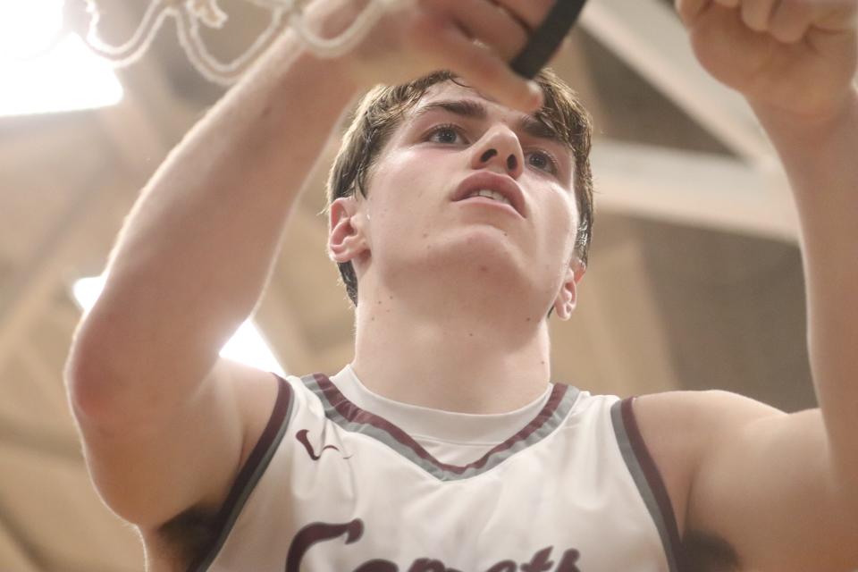 Genoa's Aiden Brunkhorst cuts down his piece of the net.