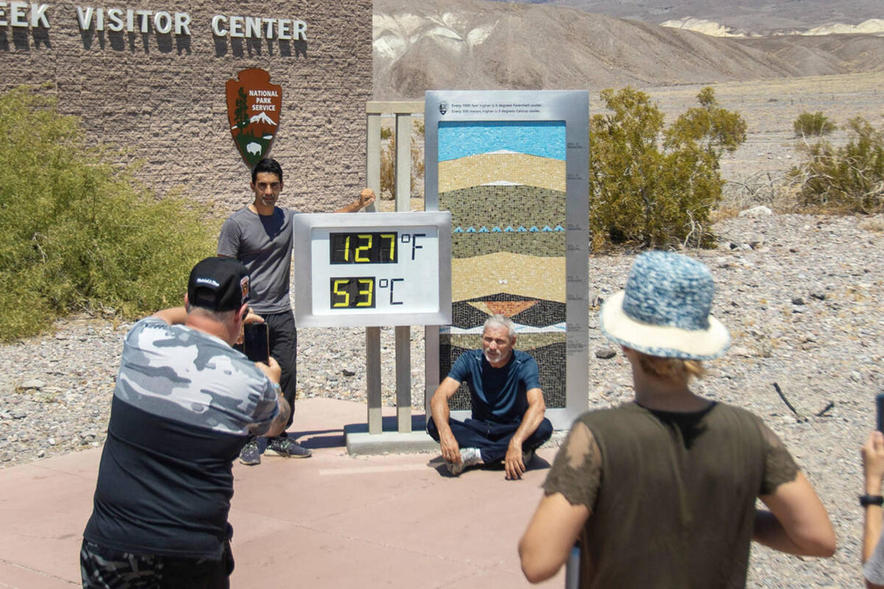 Tourists take photographs in front of the Furnace Creek Visitor Center thermometer on July 8, 2024, in Death Valley National Park, California. / Credit: Daniel Jacobi II/Las Vegas Review-Journal/Tribune News Service via Getty Images