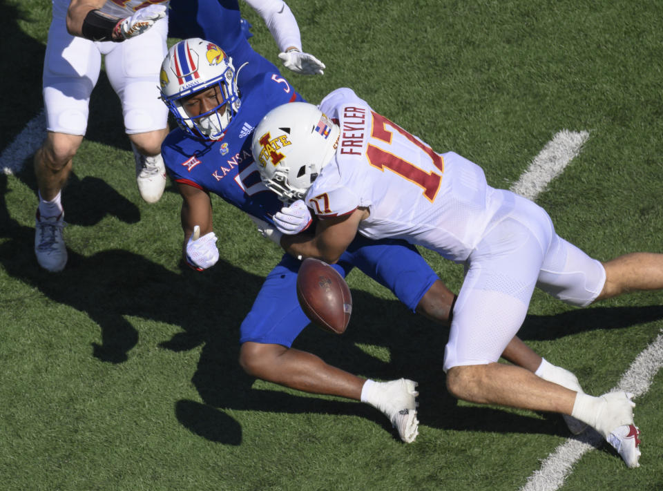 A penalty was called on Iowa State defensive back Beau Freyler (17) after he hit Kansas safety O.J. Burroughs (5) after Burroughs had called a fair catch during the first half of an NCAA college football game, Saturday, Oct. 1, 2022, in Lawrence, Kan. (AP Reed Hoffmann)