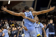 Marquette forward Justin Lewis (10) is embraced by guard Darryl Morsell (32) after their team defeated Villanova 57-54 in an NCAA college basketball game, Wednesday, Jan. 19, 2022, in Villanova, Pa. (AP Photo/Laurence Kesterson)