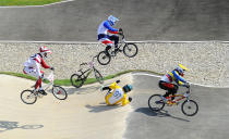 Khalen Young (AUS), #97 falls off his bike as he attempts to avoid a collision with Ea Buchely Falla (ECU), #50, and Quentin Caleyron (FRA), #14, during the men's BMX quarterfinal run in the London 2012 Olympic Games at BMX Track. (US Presswire)