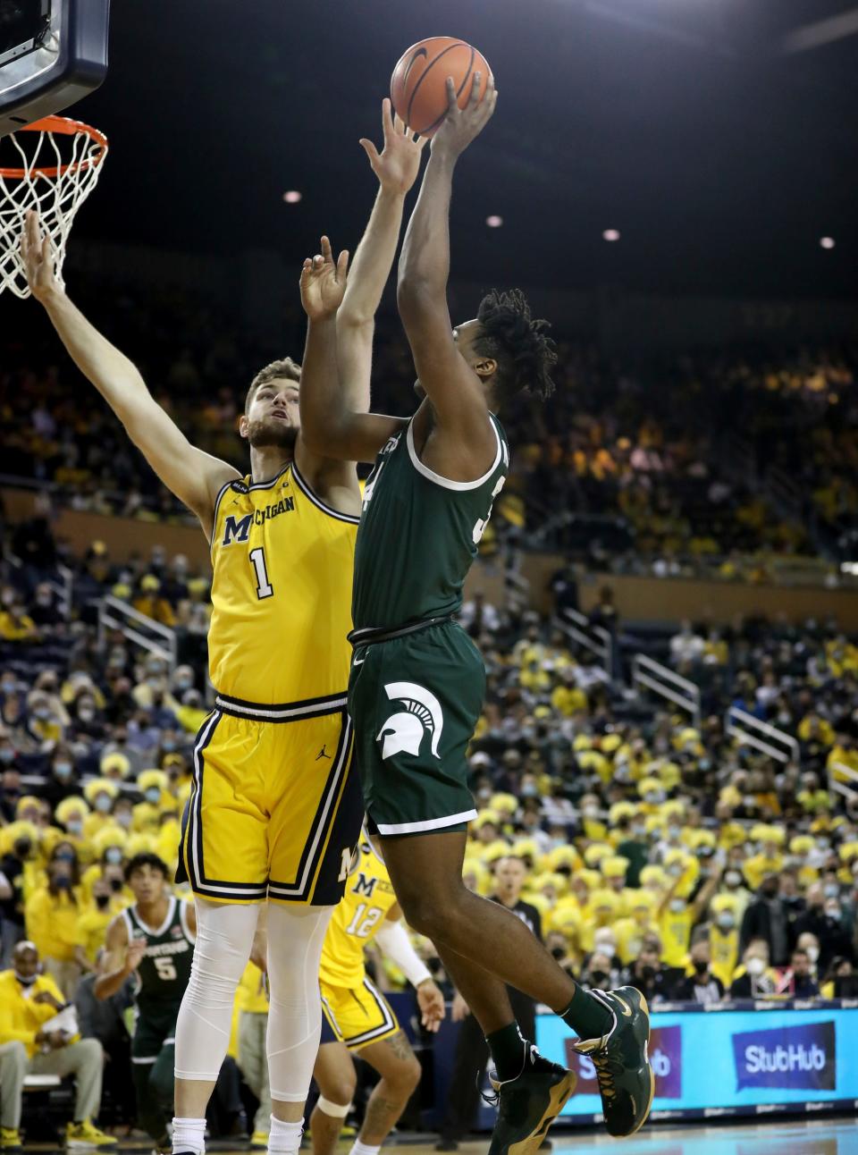 Michigan center Hunter Dickinson defends against Michigan State forward Julius Marble II during the first half on Tuesday, March 1, 2022, at Crisler Center.