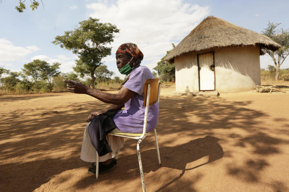 Matrida Tendayi, from Dema communal lands east of the capital Harare, Zimbabwe, talks at her homestead Wednesday, June, 23, 2021. A new surge of the coronavirus is finally penetrating Africa’s rural areas, where most people on the continent live, spreading to areas that once had been seen as safe havens from infections that hit cities particularly hard. Tendayi, who is 100 years old, said she is too frail to walk to the nearest clinic in Dema -- even if it had vaccines available. (AP Photo/Tsvangirayi Mukwazhi)