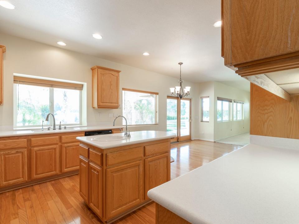 An empty kitchen with wood cabinetry.