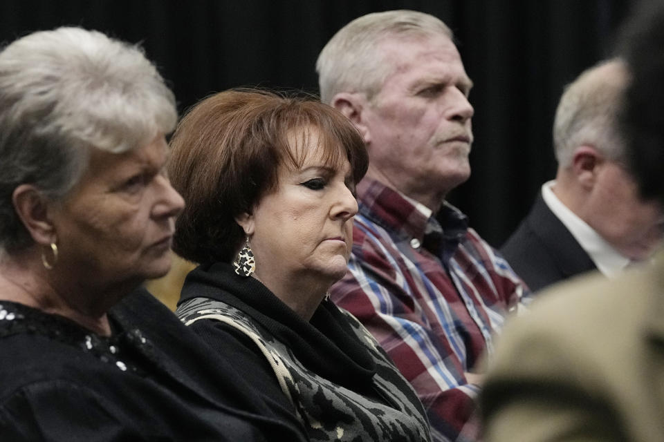 Debra Wyatt, center, the daughter of murder victims AJ and Patsy Cantrell, listens Wednesday, Dec. 7, 2022, in Oklahoma City, for Scott Eizember, who was convicted of several crimes and sentenced to death for the 2003 murder of AJ Cantrell. At left is Wyatt's friend Cindy Hightower, at right is her husband, Terry Wyatt. (AP Photo/Sue Ogrocki)