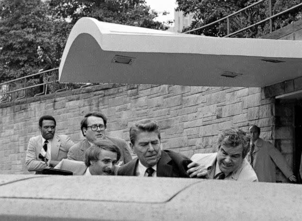 PHOTO: President Ronald Reagan is pushed into the president's limousine by secret service agents after being shot outside a Washington hotel, March 30, 1981. (Ron Edmonds/AP)
