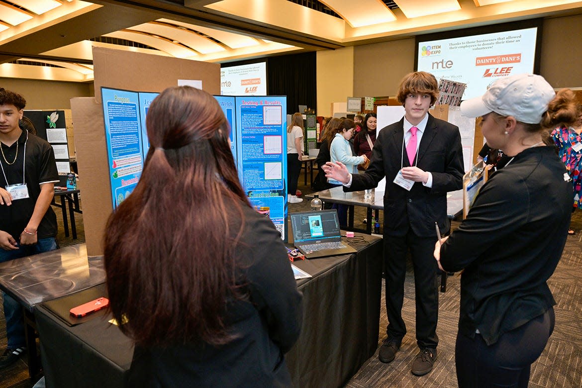 Event judge Andrea Reed, an MTSU graduate student in Mathematics and Science Education who works in the Middle Tennessee State University Tennessee STEM Education Center, listens while Oakland High freshman Kennedy Lewis, center, of Lascassas, Tenn., explains the agricultural research she and freshman Alyssa King, of Murfreesboro, Tenn., conducted during the school year. It was part of the annual Middle Tennessee STEM Innovation Hub STEM Expo, held Wednesday, April 3, in the Student Union Ballroom on the MTSU campus in Murfreesboro, Tenn.