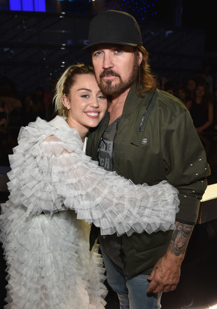 Miley smiling and hugging Billy Rae