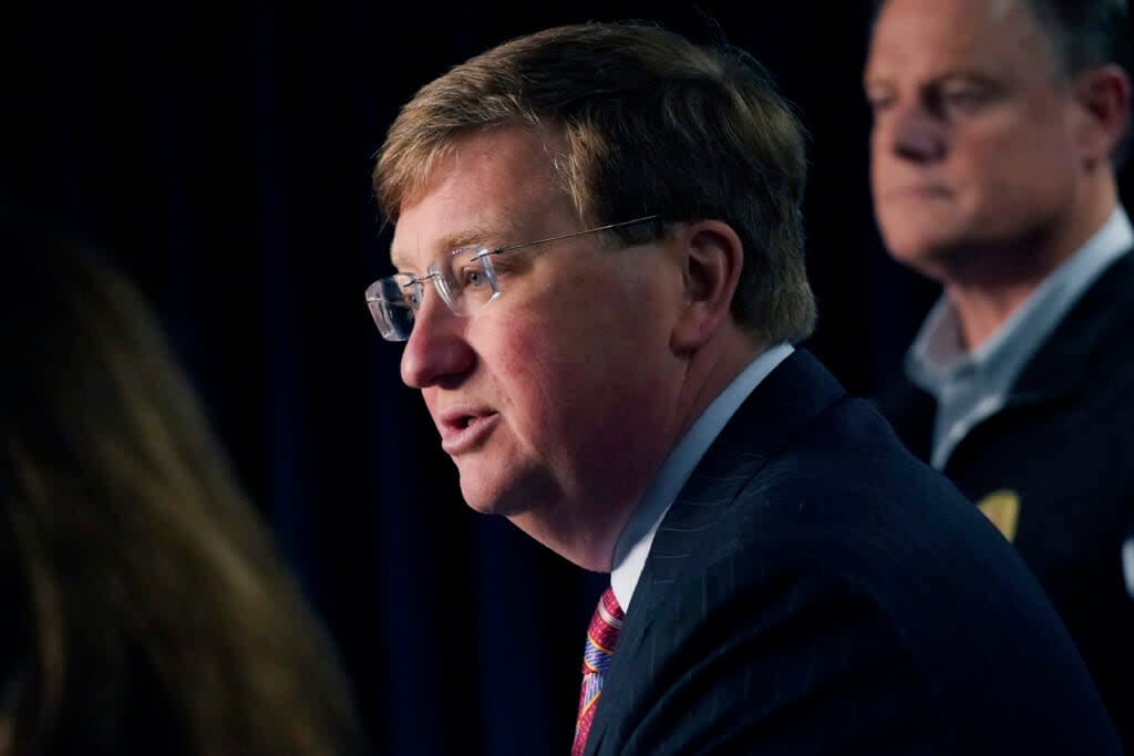 Mississippi Gov. Tate Reeves announces the state imposed boil-water notice has been lifted in Mississippi’s capital city after nearly seven weeks, while Mississippi Emergency Management Agency executive director Stephen C. McCraney, right, listens, during a Sept. 15, 2022, news conference in Jackson. (AP Photo/Rogelio V. Solis)