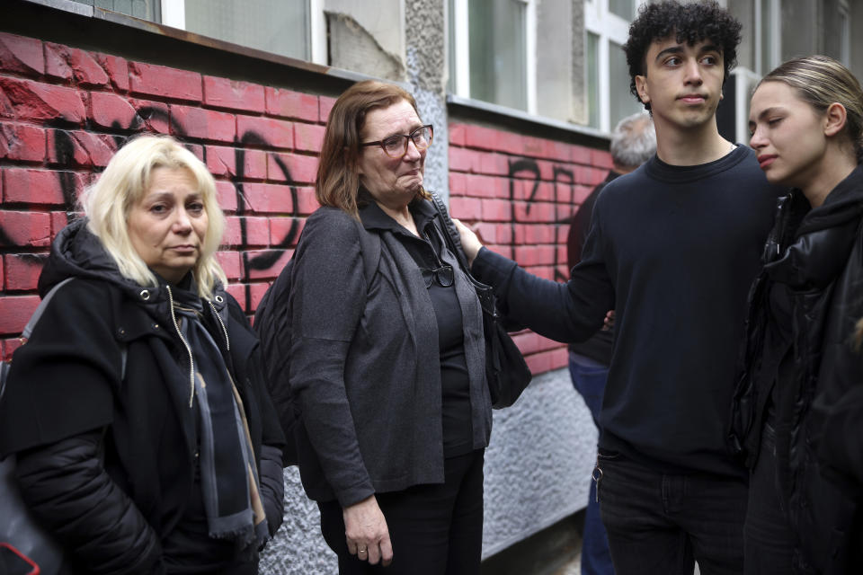 People mourn the victims near Vladislav Ribnikar school in Belgrade, Serbia, Thursday, May 4, 2023. Police say a 13-year-old who opened fire at his school drew sketches of classrooms and made a list of people he intended to target. He killed multiple fellow students and a school guard before being arrested. (AP Photo/Armin Durgut)