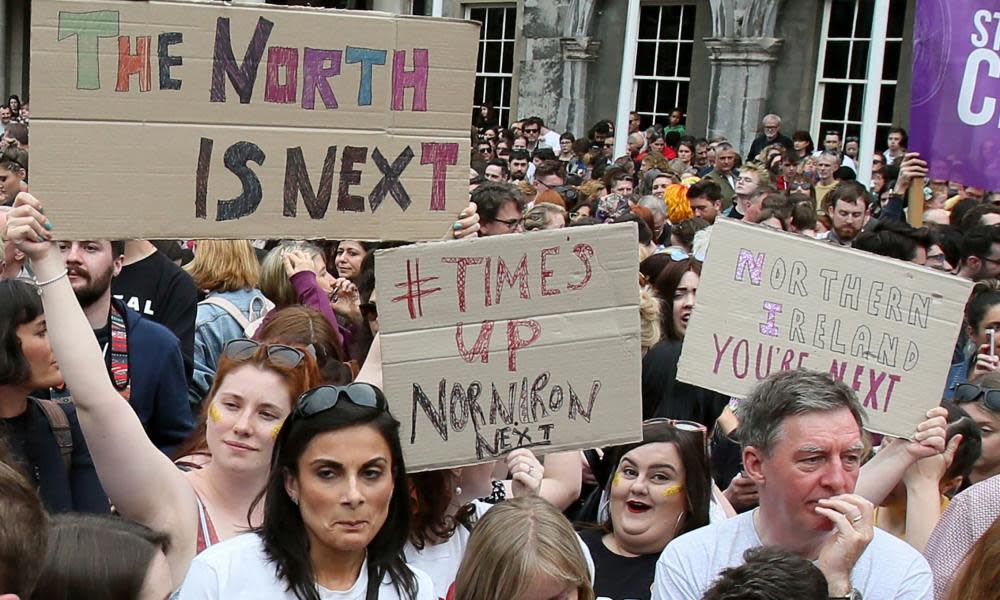 Campaigners hold posters calling for Northern Ireland to liberalise its strict abortion laws