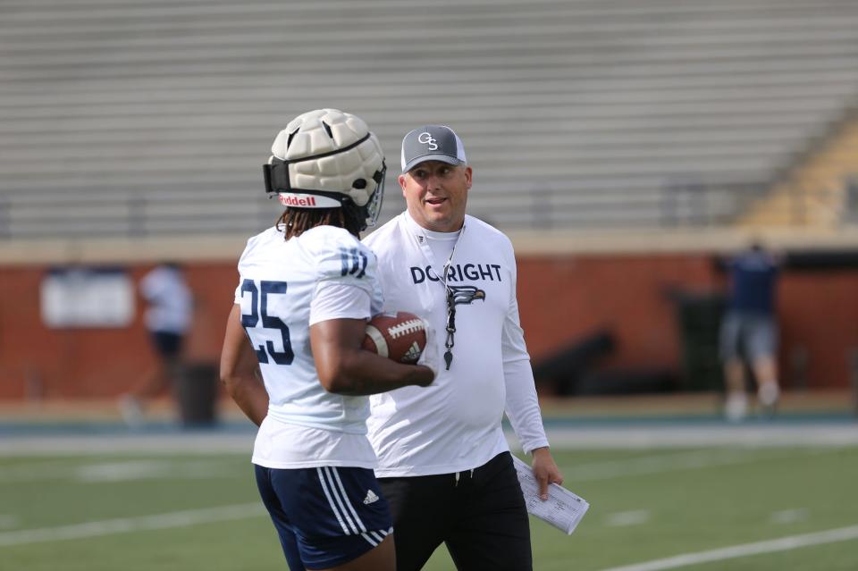 Georgia Southern head football coach Clay Helton talks with running back Jalen White during the first spring practice March 22 at Paulson Stadium in Statesboro.